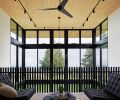 Piano room on mezzanine overlooks dining room, drawing eye to dark Modern Fan Company fixture adding contrast to stained plywood ceiling panels. Oscar coffee table grounds scene.