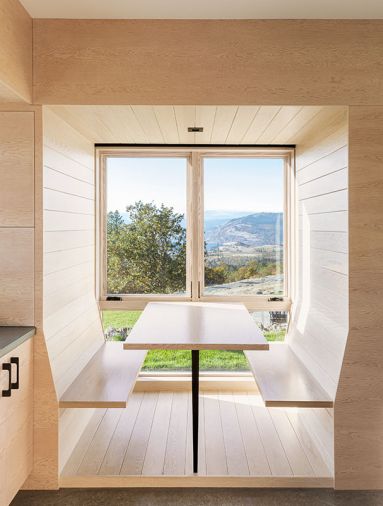 Telford + Brown designed breakfast nook as minimal perch to enjoy landscape. Bloomster and RCC executed the design to perfection, reiterating white-stained hemlock.