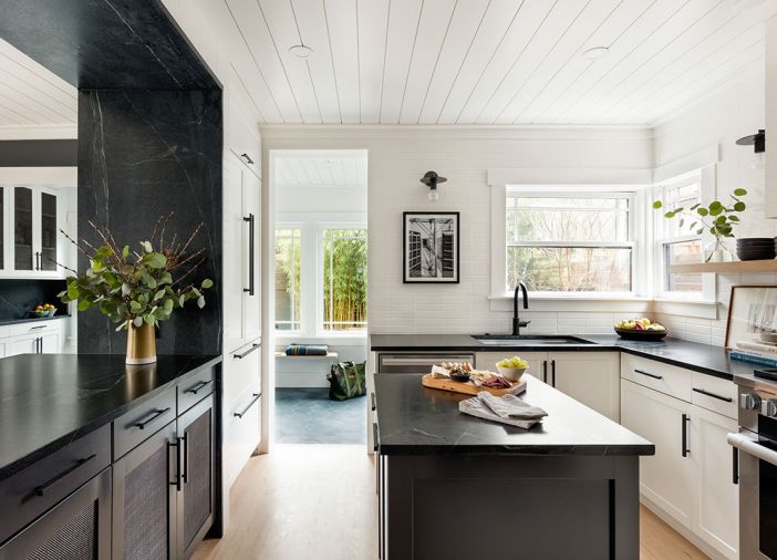 Various remodels over time created inconsistency in ceiling height and type. Pavilion lifted the kitchen ceiling to match, adding necessary volume to the small space. “Ceilings are often overlooked, but they are such a big part of the room,” said James. “The shiplap texture in white is modern and casual.” The original cabinets were kept and treated with updated hardware.