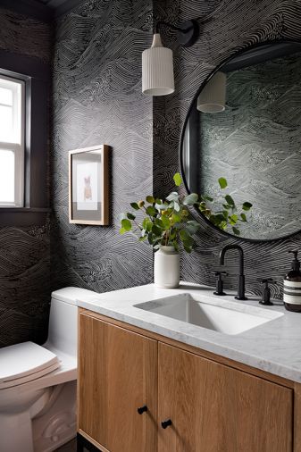 Small spaces offer the opportunity to get playful with style. “Powder rooms are one of my favorite rooms to work with,” said James. “You can have fun and make a big impact.” Boldly expanding on the homeowners’ love for the ocean, the “Eijffinger” wallpaper undulates in moody waves.