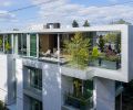 Exterior drone shot captures the glazed Argeton Terracotta panels along the Skyview front exterior. Entry door is directly below. Reflecting pond wraps past kitchen seating area to terrace alongside opening expressly designed to allow the lofting bamboo to rise through it to the fourth floor creating further privacy for the terrace.