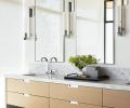 The custom oak vanity was built by Contour Woodworks with recessed hardware by Sugatsune, and with a marble counter from Bedrosians. The sconces are the Phoenix Day from Trammel Gagne at the Seattle Design Center.