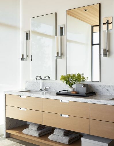 The custom oak vanity was built by Contour Woodworks with recessed hardware by Sugatsune, and with a marble counter from Bedrosians. The sconces are the Phoenix Day from Trammel Gagne at the Seattle Design Center.