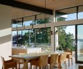 In the dining room, a Holly Hunt chandelier is suspended above a custom oak dining table from Arden Home, the latter surrounded by leather Cassina Cab chairs.