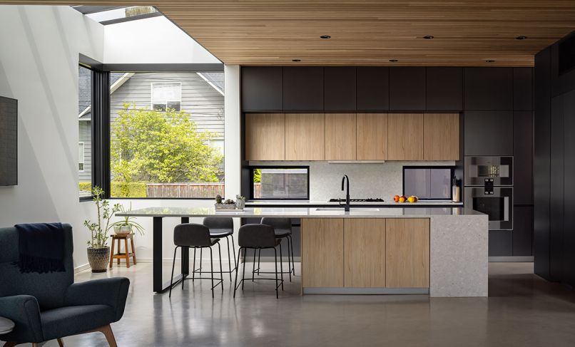 Stepping back the third floor enabled Stephenson to incorporate a Crystalite skylight from Cherry Creek Windows & Doors into the kitchen, flooding the room with natural light. A clear cedar ceiling further grounds the space, as does the Leicht cabinetry with Metea and Japanese Pine finishes, paired with a Pental Terreno backsplash and counters. The floors are stained and sealed concrete. Integrated appliances from Gaggenau, Fisher Paykel, and Thermador keep visual clutter to a minimum.