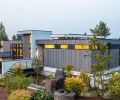 The home’s exterior is decidedly modern, including Hardi Panel and Trim Lap siding painted in a sleek Charcoal and Black Ink from Benjamin Moore. The custom door by Pivot Door Company is reached via an elevated walkway.