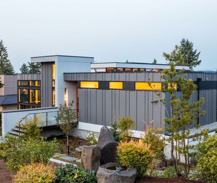 The home’s exterior is decidedly modern, including Hardi Panel and Trim Lap siding painted in a sleek Charcoal and Black Ink from Benjamin Moore. The custom door by Pivot Door Company is reached via an elevated walkway.