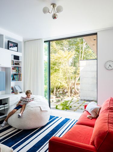 Custom cabinets in family and entertainment room are complementary to the white cabinets upstairs. The children’s rooms accommodate special interests and collections with built-in storage and display fixtures.