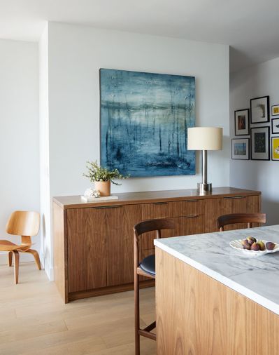 Fry admires the craft of the cabinetmakers and stone installers: Both “did a nice job grain matching and following the grains through all of the pieces to make it look flawless,” says Fry. Plain-sawn walnut was used for the standalone sideboard and island base, both fabricated by Precision Custom Cabinets.