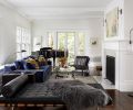 Krieg enlivens living room with black leather Barcelona bench, Restoration Hardware faux throw and blue velvet Holly Hunt sofa. Pop of orange from Housewright pillows. John Pomp Studios floor lamp. Michael Schultheis artwork from Winston Wachter Fine Art.