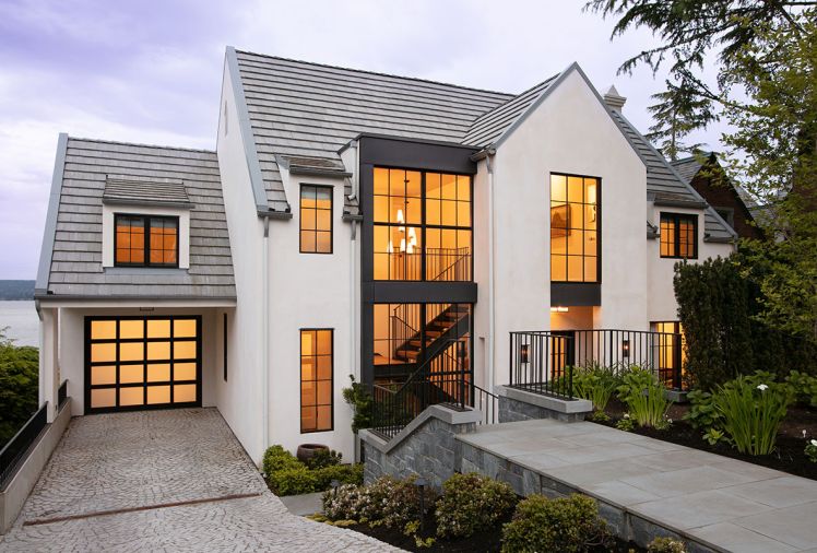 Concrete Florida rooftile and gutters counter stonewalled staircase to main entrance. Tandem parking available in adjacent driveway.