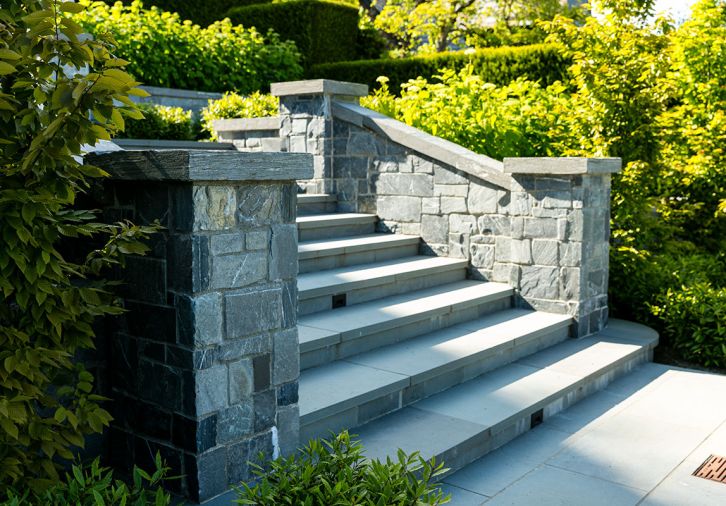 Handsome staircase features bluestone pavers and K2 Stone walls.