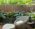 Furniture takes on organic forms communing with the natural surroundings, like the West Elm Montauk Chair and the stone-shaped ottoman by Soma Stone. A gunmetal steel wall softened with horizontal cedar slats clarifies the room without feeling boxed in. Affectionately dubbed “Yann’s deck,” the homeowner wanted a private place to work outside, or linger meditatively surrounded by lush greenery.