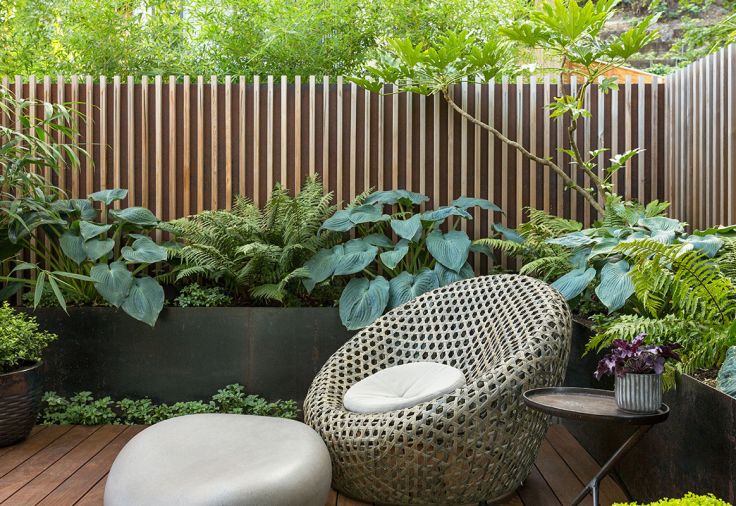 Furniture takes on organic forms communing with the natural surroundings, like the West Elm Montauk Chair and the stone-shaped ottoman by Soma Stone. A gunmetal steel wall softened with horizontal cedar slats clarifies the room without feeling boxed in. Affectionately dubbed “Yann’s deck,” the homeowner wanted a private place to work outside, or linger meditatively surrounded by lush greenery.