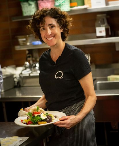 Executive Chef Annie Cuggino at work in her open kitchen enjoys engaging with her guests about the fine elements of her cuisine.