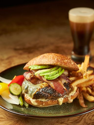The very popular Q Burger with bacon, house pickles, white cheddar, remoulade, and hand cut fries.