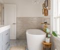 Signature Hardware tub warmed by handmade Zia tile and Waterworks Brass plumbing. The Light Factory chandelier draws eye toward view.