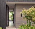 The house’s design “lets the landscape come forward as the main visual element,” says Wittman. The entry pivot door is by Quantum.