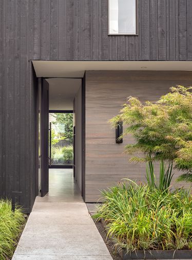 The house’s design “lets the landscape come forward as the main visual element,” says Wittman. The entry pivot door is by Quantum.