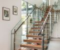 A custom staircase with white oak treads inset with LED lights, a stringer by Splice Welding and Design, and railing system by Missoula Blacksmith, lends airiness to the room.