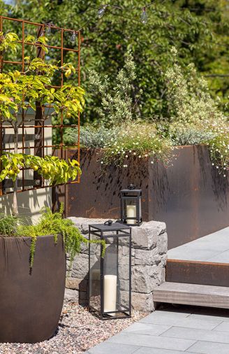 David Bertman Designs fabricated custom planter boxes, geometric firepit, curved bench, intermediate stair, steel trellis, and steel siding.