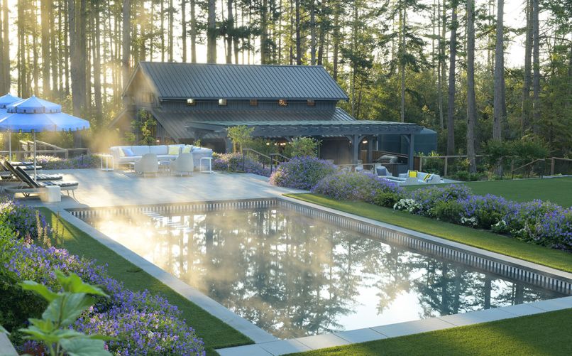 Land Morphology’s profuse Geranium ‘Rozanne’ pool border also features miniature Bobo Hydrangeas and ‘Wintergreen’ Boxwood. McKinnon & Harris sectional. Holly Hunt tables from Jennifer West Showroom at SDC. Janus et Cie armchairs. LM’s pergola design spans the former garage turned party barn, where their outdoor kitchen features DCS 7 Grill and DCS drawers and access doors - Wygal Builders install. Stone counter and backsplash are Pietra di Cardoso Schist installed by Architectural Stone Werkes.