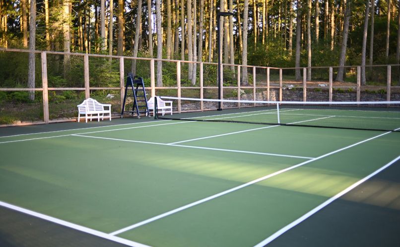 10-foot sports fencing encloses tennis courts above left.