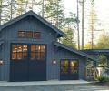 Dark Gray (Benjamin Moore “Cheating Heart”) swinging barn doors by Real Carriage Door Company mark the entrance to the party barn contrasting with Benjamin Moore “Stormy Sky” wood siding. Land Morphology’s pergola, right, features arched braces attaching to posts and painted to match the building.