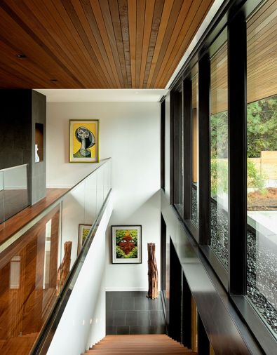 Western Red Cedar vertical slats, from Lakeside Lumber, cover the ceiling and roof overhang. The windows are by Quantum Windows & Doors.