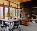 The focal point of the great room is the dramatic fireplace wall, flanked by wood storage and bookshelves. An insert from Wittus – Fire by Design is surrounded by site-built hot-rolled steel from Johnsen Steel Works. An Eternity Modern sofa sits beneath a Minka-Aire Extreme H2O Ceiling Fan. In the dining room, a Bent Dining Table from Moe’s Home Collection is surrounded by Hay chairs.