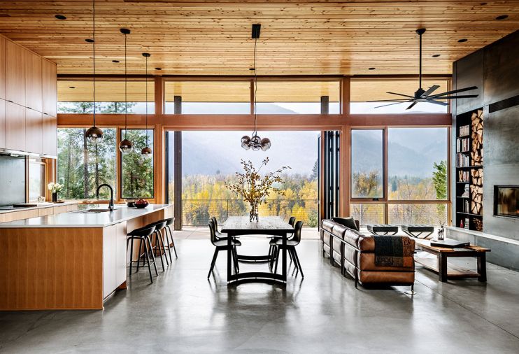 A NanaWall System and Sierra Pacific Windows from North Valley Lumber frame the beautiful views and open to the covered veranda. Kitchen barstools from Hay offer easy conversation during meal prep. Kirkham Tufted leather stools from Pottery Barn in the living space can be utilized for a chat around the fire or easily adjusted to enjoy the scenery.