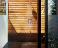 The outdoor shower connected to the primary suite bathroom is another seamless indoor/outdoor moment. Frosted glass on one side fosters privacy, and a clear letterbox window enables views to the water. A living green wall softens the interior, and no ceiling makes it possible to shower under the stars.