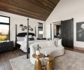 Noir bed and nightstand softened by the curve of a Bernhardt sofa facing an unseen Mutual Materials brick fireplace. Jon Dorr custom sliding barndoor adds privacy. Dalia rug from Atiyeh Bros.