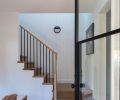 The entry foyer features the same engineered oak flooring, by D&M Flooring and from CFM, that’s used throughout, as well as a door from Pinkies Iron Doors.