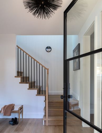 The entry foyer features the same engineered oak flooring, by D&M Flooring and from CFM, that’s used throughout, as well as a door from Pinkies Iron Doors.