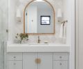 In a guest bathroom, the vanity is topped with a Caesarstone counter from Elemar, and has hardware from Inspire Hardware.