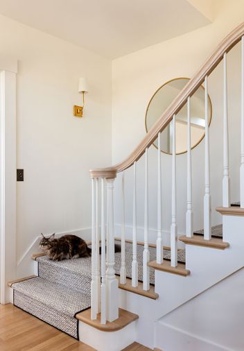Dutchess, the cat, gets cozy on the Stanton runner from Associated Designer’s Showroom. The stairs were designed by K&L Interiors and built by Beautiful Custom Stairs, Inc.