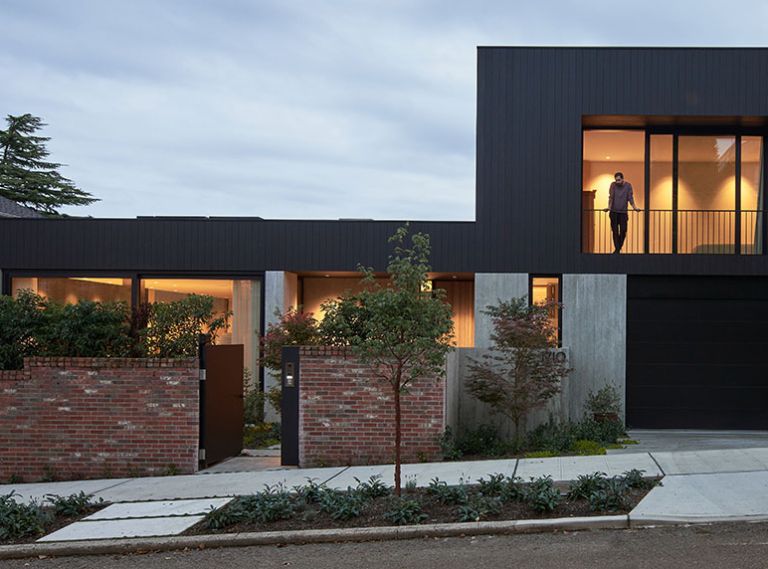 Architect Daniel Toole created a soft organic texture in the concrete, executed exceptionally by Fieldworks Custom Concrete. The board-formed imprint is the inverse of the upper-level burnt Accoya Shou Sugi Ban shiplap siding. Elegant wood from Delta Millworks uses the traditional Japanese technique of curing wood with smoke. Hewn Elements provided front door cladding. The brick wall was preserved from the original property.