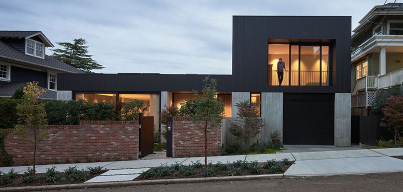 Architect Daniel Toole created a soft organic texture in the concrete, executed exceptionally by Fieldworks Custom Concrete. The board-formed imprint is the inverse of the upper-level burnt Accoya Shou Sugi Ban shiplap siding. Elegant wood from Delta Millworks uses the traditional Japanese technique of curing wood with smoke. Hewn Elements provided front door cladding. The brick wall was preserved from the original property.