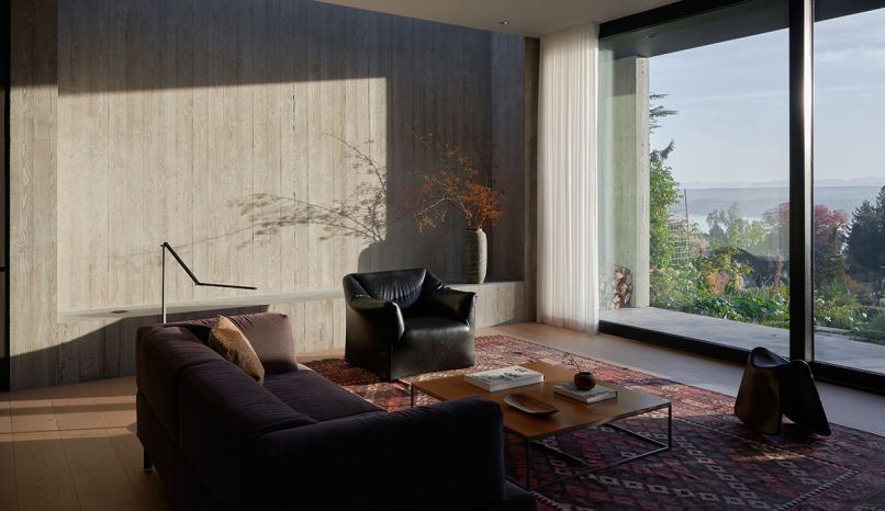 The owners’ iconic Italian modernist furniture collection is at home next to inviting curtains from Pacific Window Coverings.