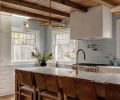 Custom cabinets designed by Jessica Nelson Design and built by Superior Cabinets surround the kitchen. Fireclay tiles expand beyond the backsplash filling the space with counter-to-ceiling organic texture. Circa hanging lights are a little bit vintage and a little bit modern. Brass plumbing from Ferguson and Rejuvenation hardware are a nod to old-timey hues.