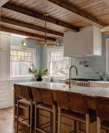 Custom cabinets designed by Jessica Nelson Design and built by Superior Cabinets surround the kitchen. Fireclay tiles expand beyond the backsplash filling the space with counter-to-ceiling organic texture. Circa hanging lights are a little bit vintage and a little bit modern. Brass plumbing from Ferguson and Rejuvenation hardware are a nod to old-timey hues.