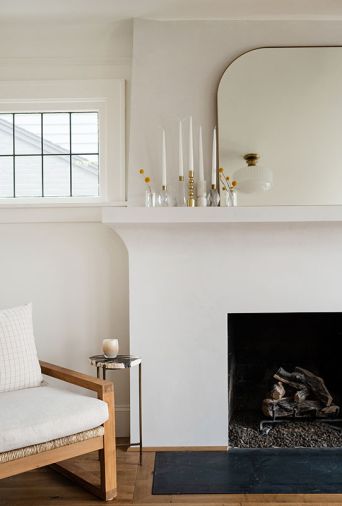 Upstairs, the serene white walls in Benjamin Moore “White Dove” and minimalist fireplace surround allow the homeowner a blank canvas for evolving décor.