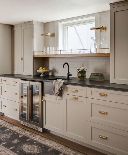 Downstairs, Nelson leans into the speakeasy era with a custom bar shelf and Circa brass sconces. What was once a dark and unappealing basement has been transformed to a bright entertainment zone.