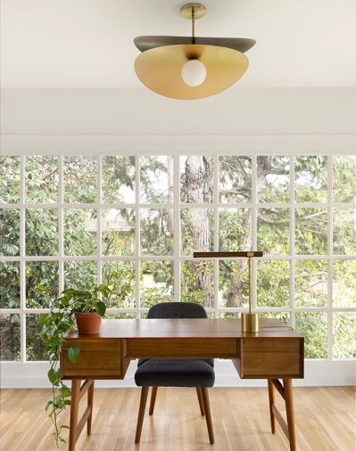 Wise Design, Sasquatch Architecture, and Soren Clark of Owen Gabbert, LLC overhauled this 1922 Alameda Ridge house in Portland from top to bottom. In the office, an original window was preserved and joined with a mid-century desk, upholstered dining chair, and Olivia Pendant, all from West Elm.