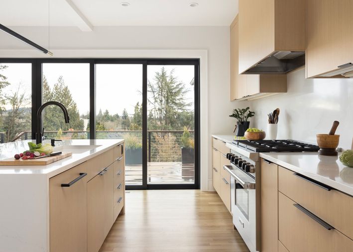 The kitchen appliances, like the Vent-a-Hood liner, Wolf range, Miele dishwasher, and Sub-Zero fridge, are from Basco Appliances. The La Cantina sliding door was sourced from Parr Design Center.