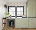 At the kitchen bar, Uni Mountain tile from Fireclay Tile covers the wall. The cabinetry, designed by Wise Design and built by Soren Clark of Owen Gabbert, LLC, is painted in ‘Treron’ from Farrow & Ball, and the honed Brazilian soapstone counter is from Classique Marble & Granite.