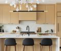 The kitchen is outfitted in custom rift-sawn white oak cabinetry, designed by Wise Design and built by Soren Clark of Owen Gabbert, LLC. Polished Silestone in ‘Calacatta Gold’ from Classique Marble & Granite provides the counter and backsplash.