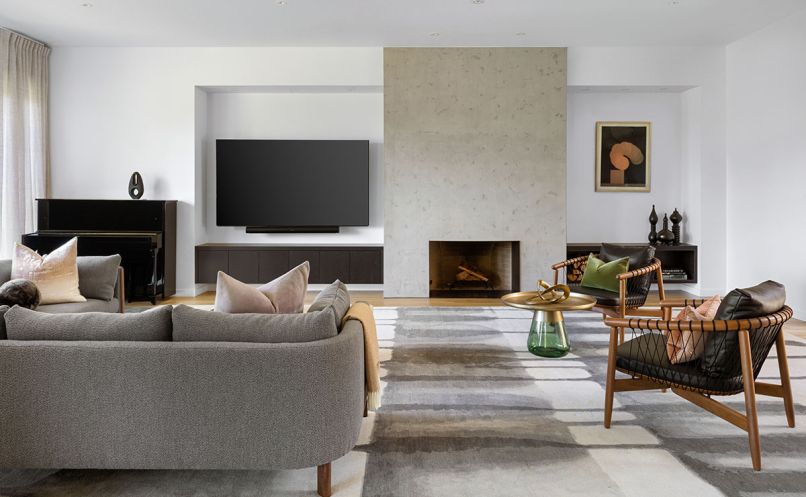 Roche Bobois artwork draws eye to newly crafted fireplace with concrete trowel finish by Bravura Finishes. Driscoll Robbins and YERRA rug (both pages) from SMG Collective.