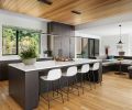 A wall removal opens kitchen to family room and beyond. BlueStar range, Vent-A-Hood liner and Sub-Zero fridge from Eastbank Contractor Appliances. Roche Bobois artwork adorns desk shelving.